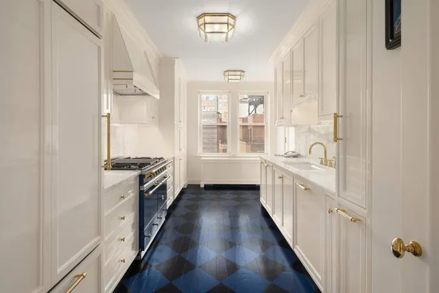 a view of a dining room with furniture and a large window