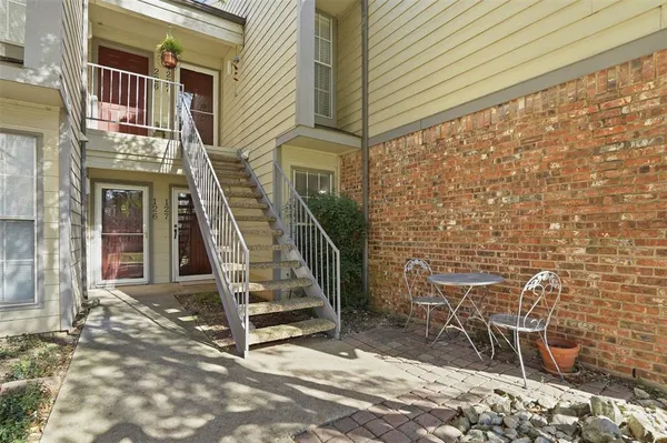 a view of front door of house with stairs