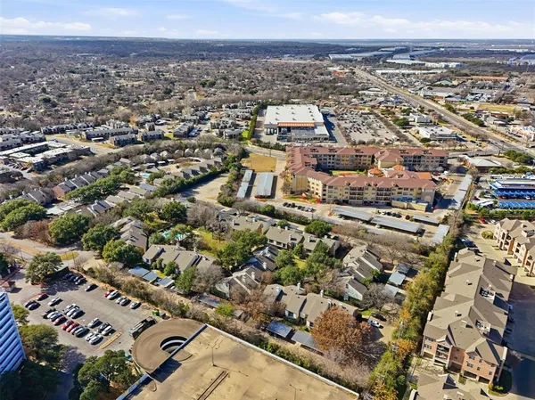 an aerial view of residential houses with city view