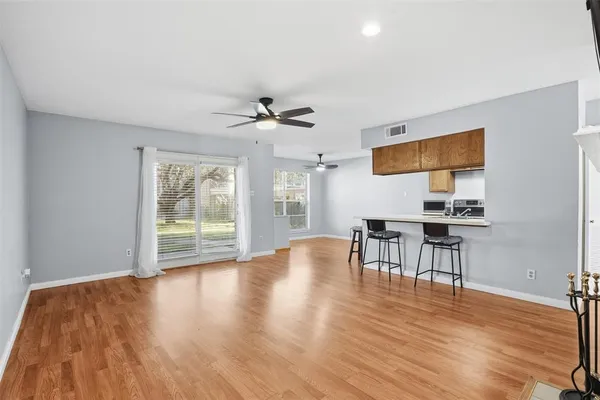a view of a livingroom with furniture wooden floor and window