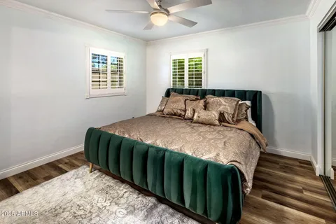 a bedroom with a bed and a mirror