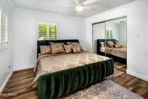 a bedroom with a bed and a flat tv screen on wall