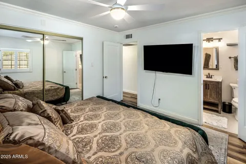 a bathroom with a sink a toilet a mirror and shower