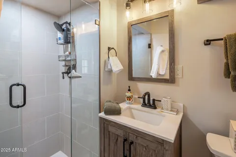 a large bed sitting in a bedroom next to a window