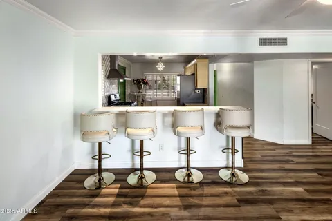 a view of a room with wooden floor