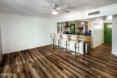 a view of a room with wooden floor and furniture