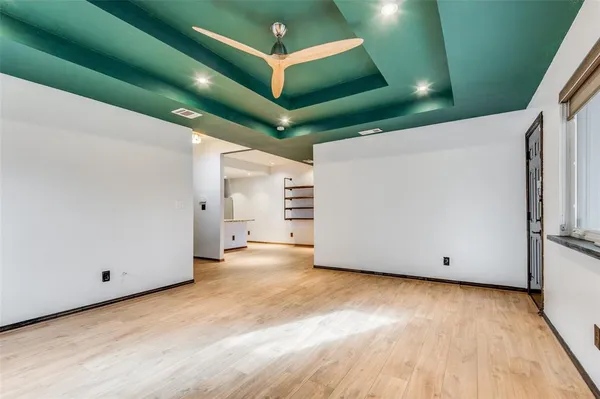 a view of a room with wooden floor