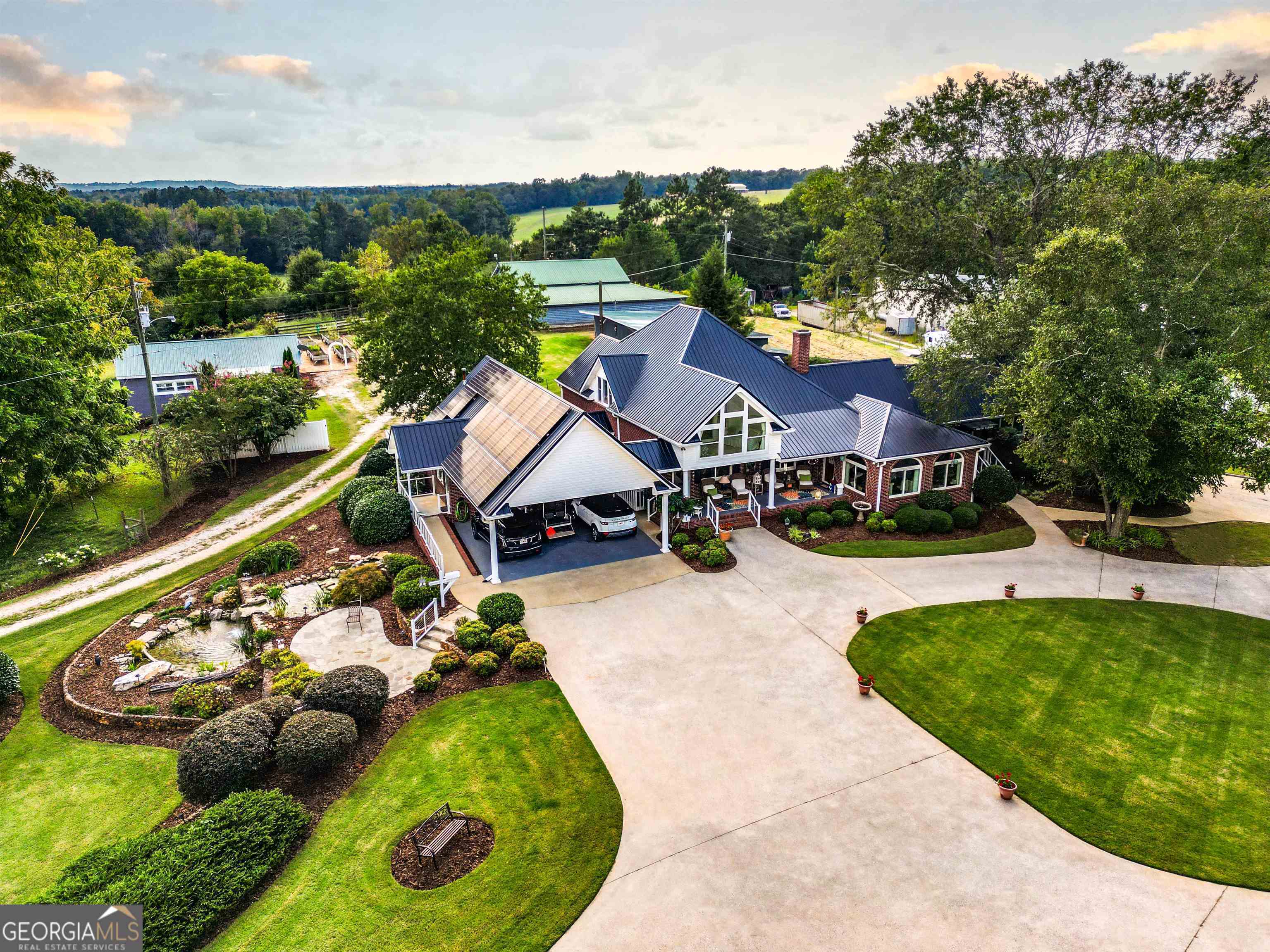 a aerial view of a house with swimming pool garden and lake view