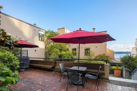 a view of a table and chairs under an umbrella in patio