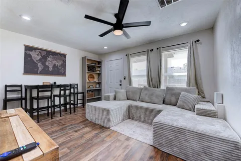 a bedroom with furniture and a large window