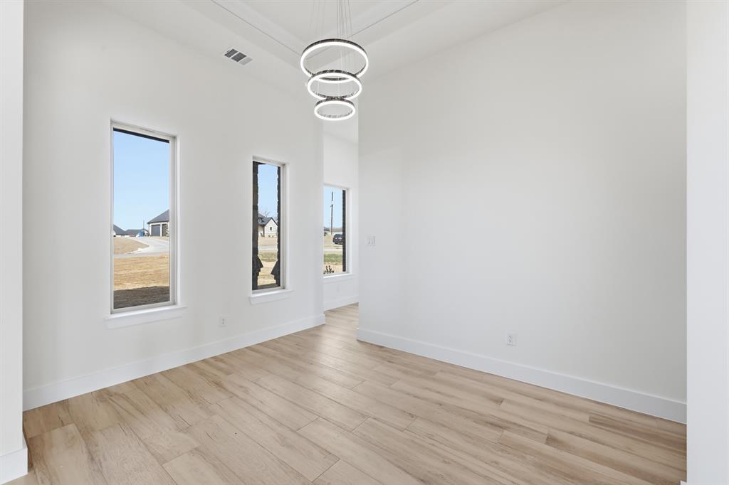 150 Briar Patch Azle, TX 76020 - Photo 12 of 40 an empty room with wooden floor and windows