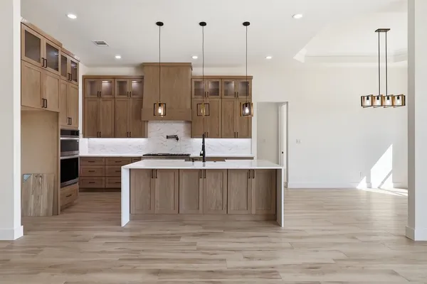 a kitchen with stainless steel appliances granite countertop a sink stove and refrigerator