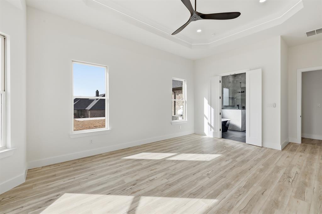 150 Briar Patch Azle, TX 76020 - Photo 30 of 40 a view of a livingroom with wooden floor and a ceiling fan
