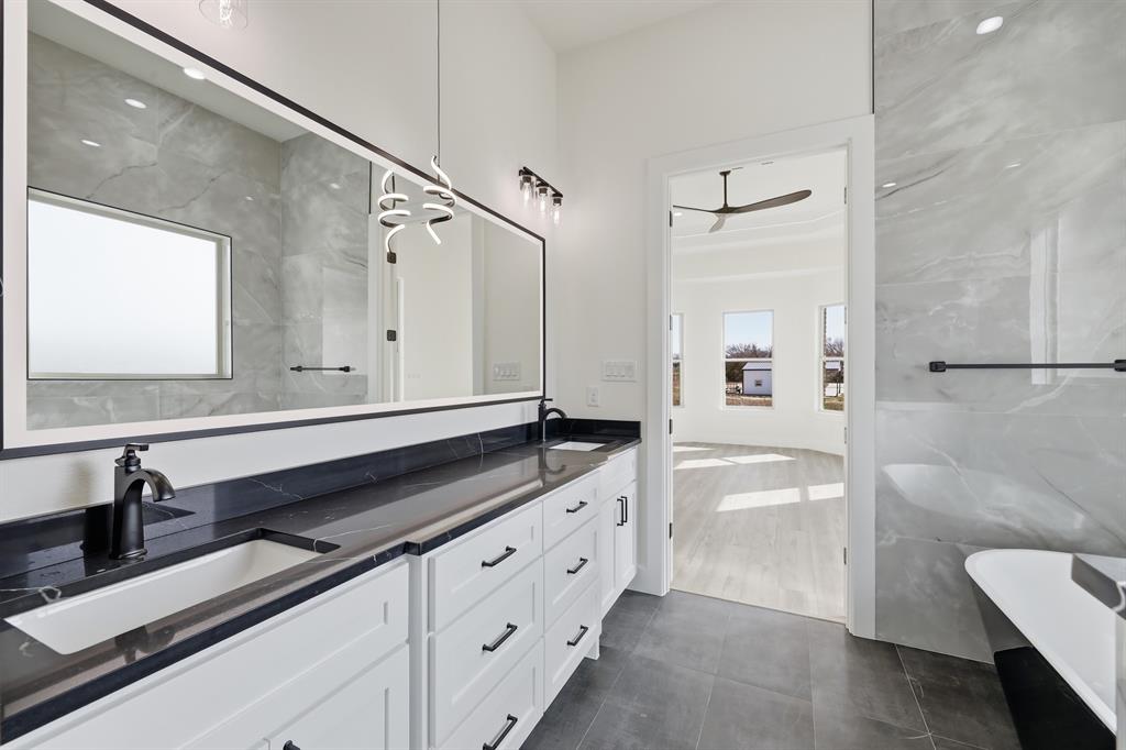 150 Briar Patch Azle, TX 76020 - Photo 34 of 40 a spacious bathroom with a granite countertop sink a toilet a mirror and shower