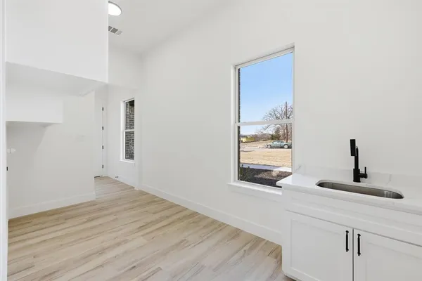 a view of an empty room and wooden floor