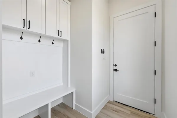 a view of storage and utility room with wooden floor