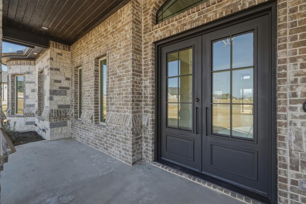 150 Briar Patch Azle, TX 76020 - Photo 5 of 40 Look at that elegant iron front door and quaint porch, perfect for rocking chairs.
