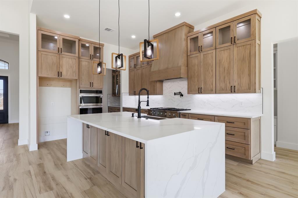 150 Briar Patch Azle, TX 76020 - Photo 7 of 40 Waterfall island and elegant stained cabinets.