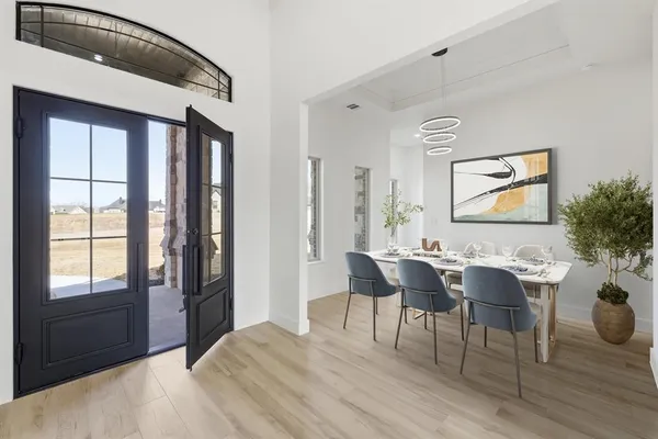 an aerial view of a house with a garden and lake view