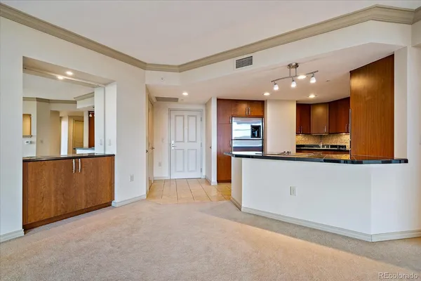 a view of kitchen with refrigerator and a sink