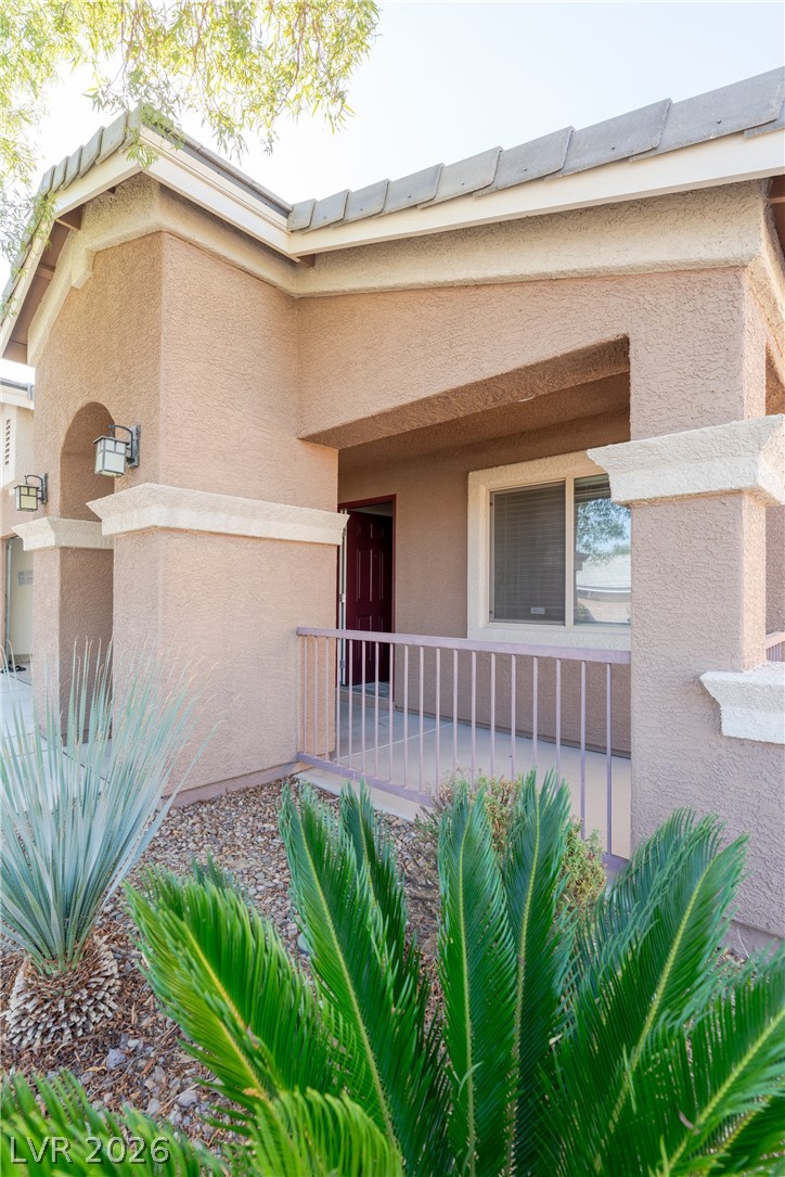 8079 Buffalo Ranch Avenue Las Vegas, NV 89147 - Photo 3 of 29 An inviting front porch features stucco detailing and desert plantings near the entry.