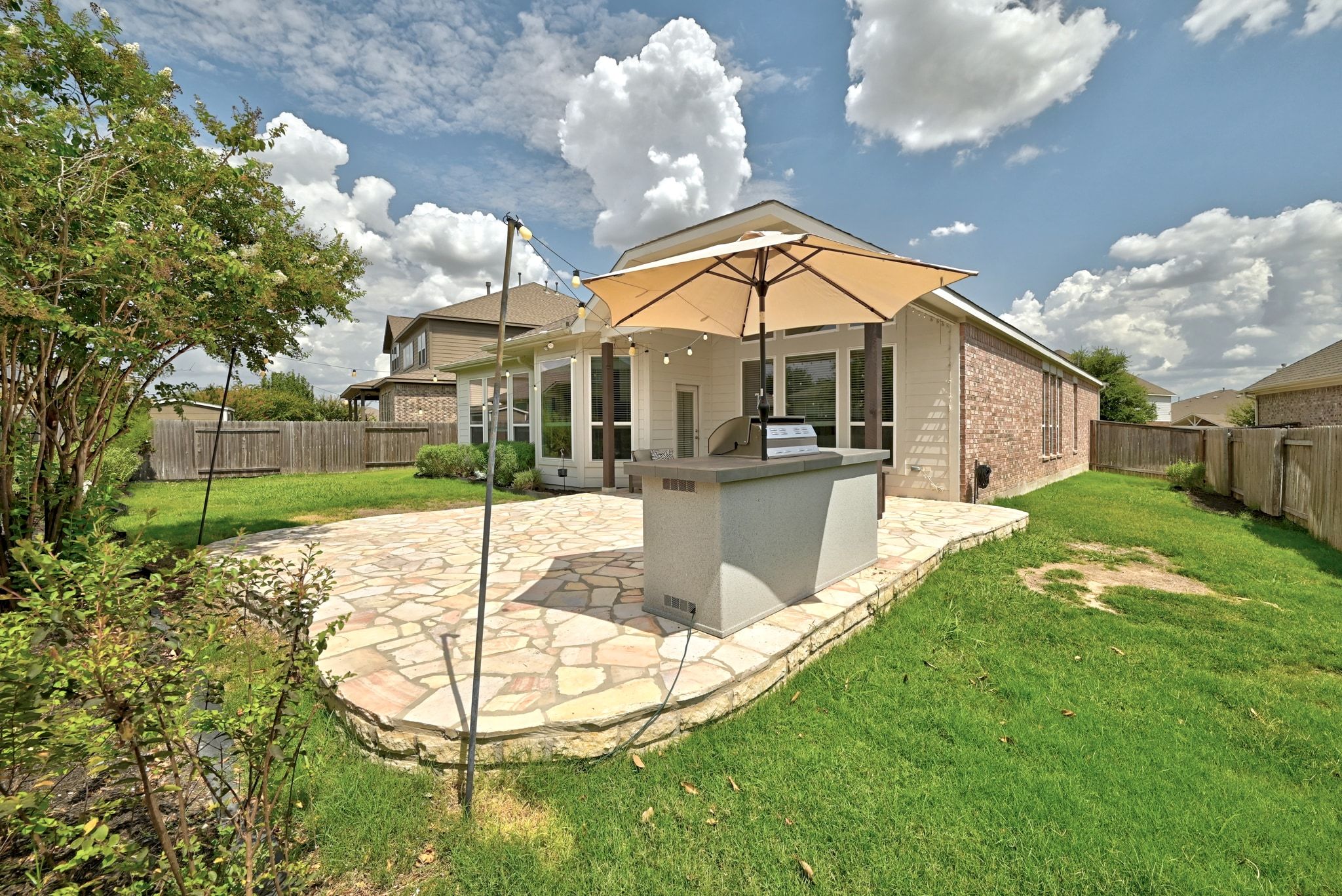19620 Stanton Drew Pflugerville, TX 78660 - Photo 29 of 33 Rear view of property with a patio area, exterior kitchen, and a fenced backyard