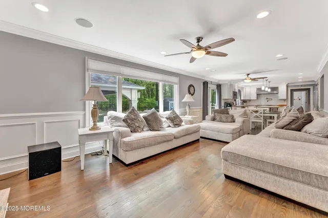 a living room with furniture and a ceiling fan