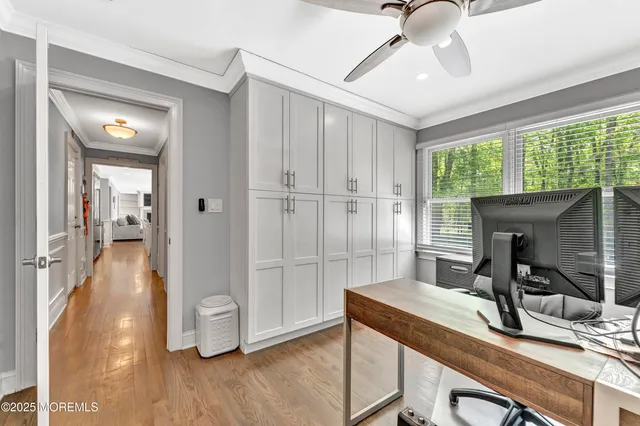 a view of a workspace with furniture and a window