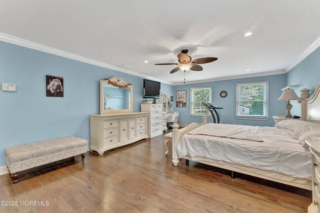 a bedroom with a large bed and a chandelier