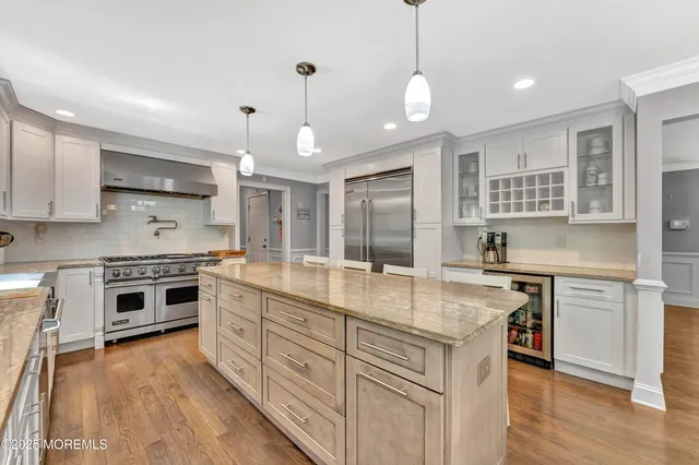 a kitchen with stainless steel appliances granite countertop a stove oven and a sink
