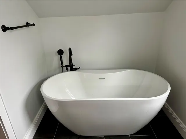 a white tub sitting next to a sink