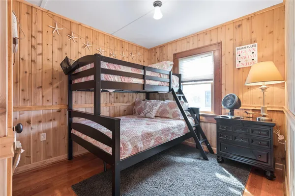 a bedroom with a bunk bed and a window