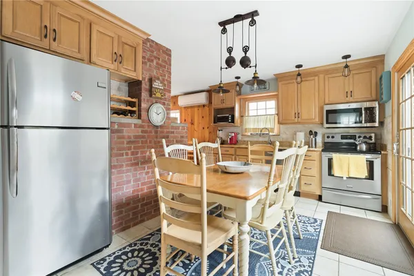 a kitchen with stainless steel appliances a refrigerator and a stove top oven