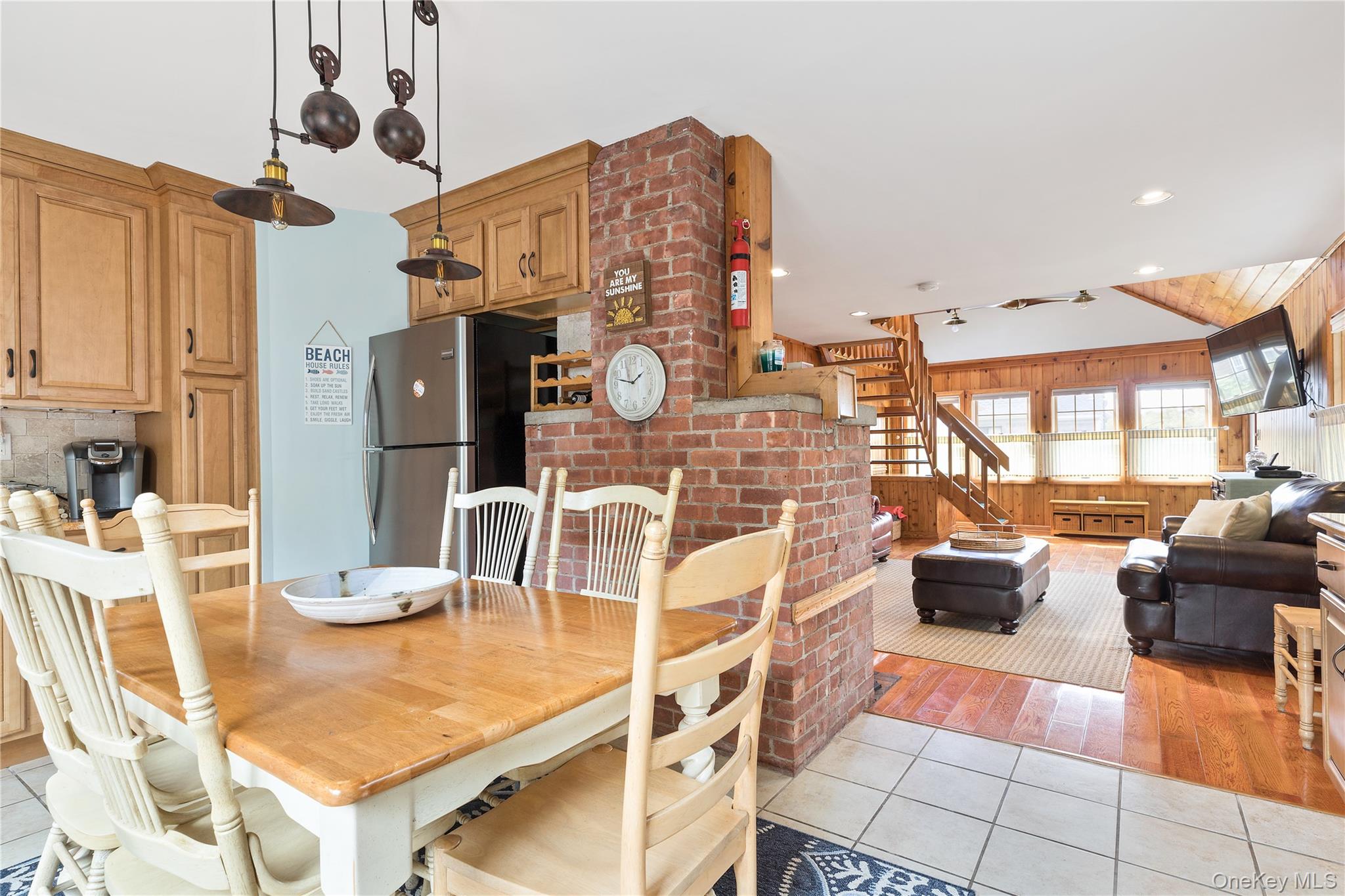 19 Ocean Road Ocean Beach, NY 11770 - Photo 3 of 20 a living room with furniture a flat screen tv and kitchen view