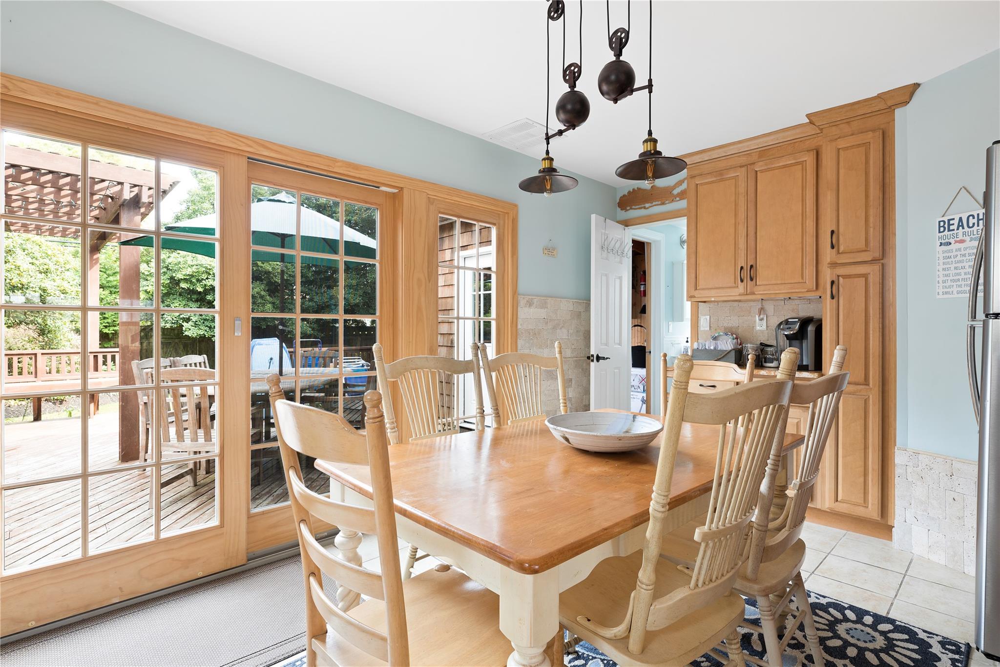 19 Ocean Road Ocean Beach, NY 11770 - Photo 4 of 20 a dining room with stainless steel appliances kitchen island granite countertop a table and chairs