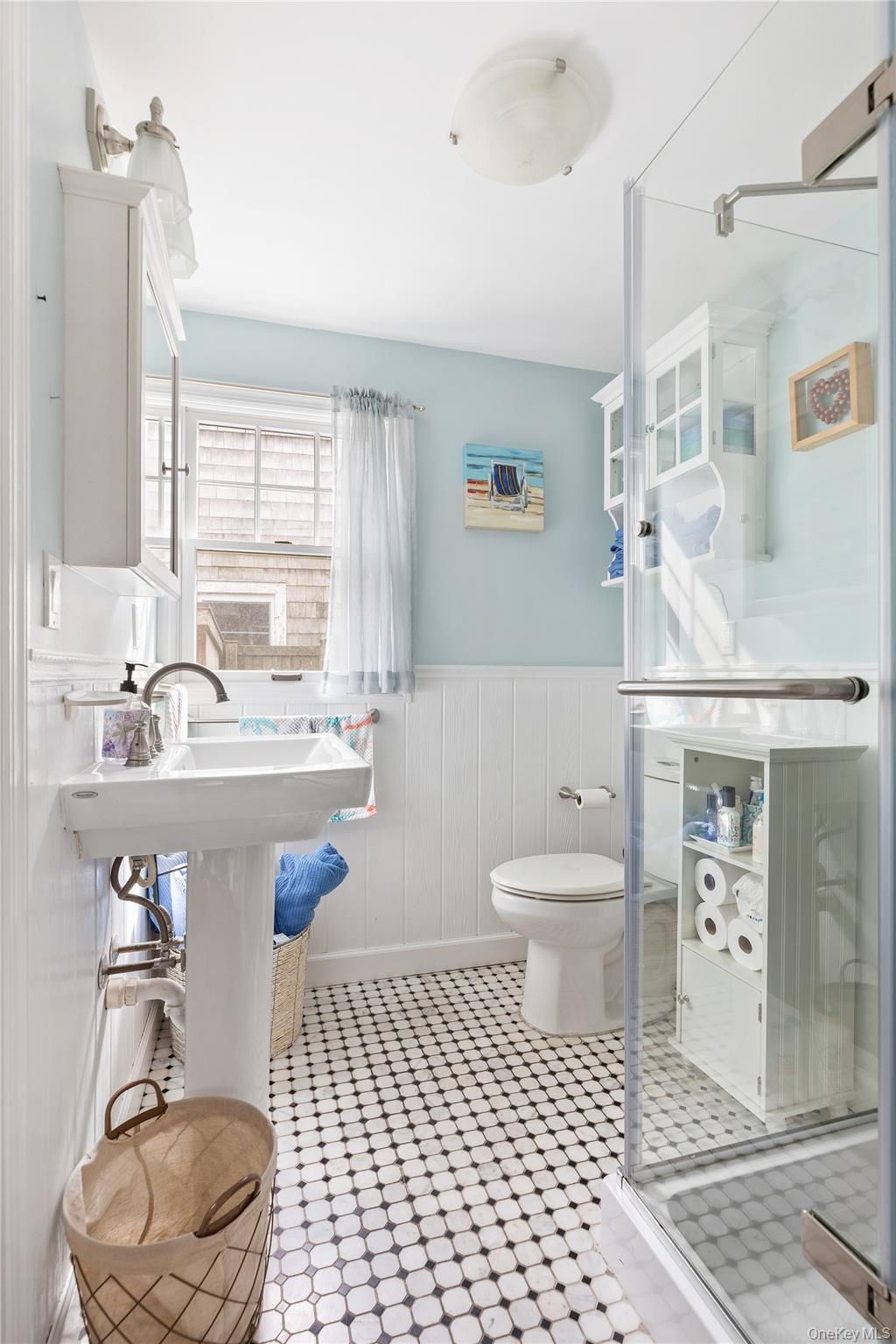 19 Ocean Road Ocean Beach, NY 11770 - Photo 8 of 20 a bathroom with a sink a toilet and a mirror