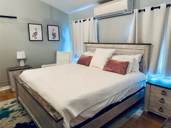 a bedroom with a bed and a wall painting