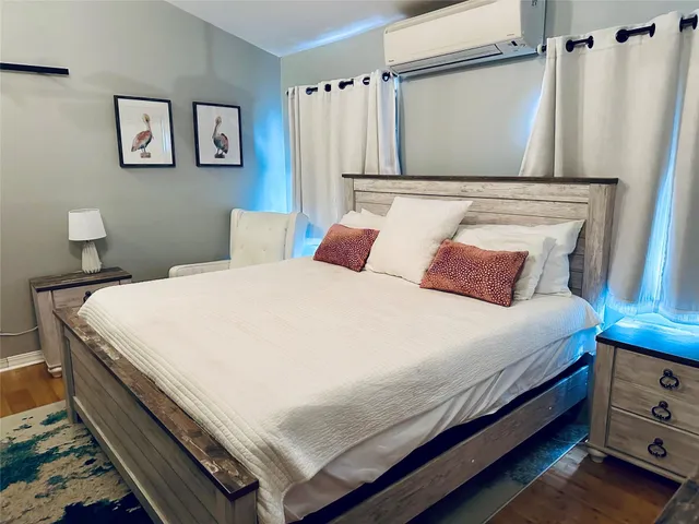 a bedroom with a bed and a wall painting