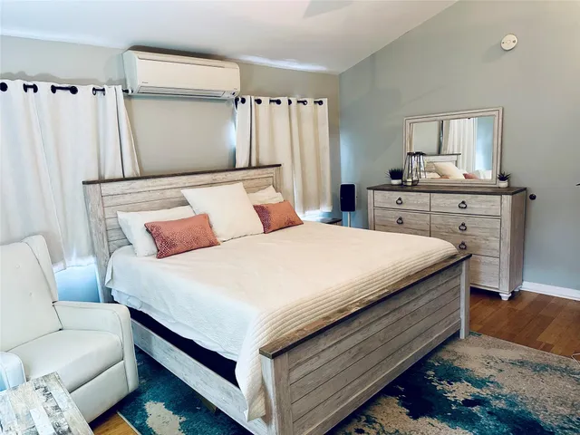 a bedroom with a bed and a chair