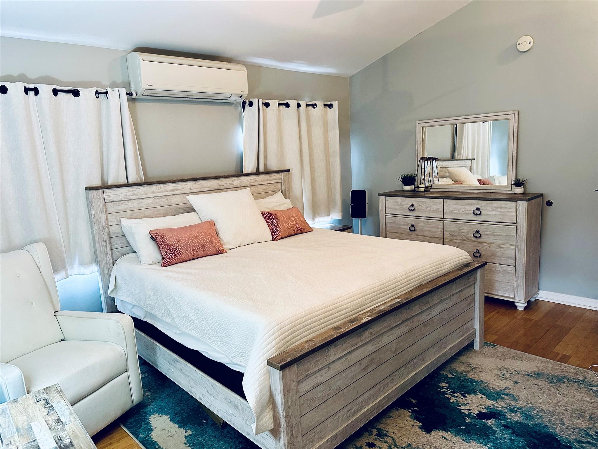 19 Ocean Road Ocean Beach, NY 11770 - Photo 10 of 20 a bedroom with a bed and a chair