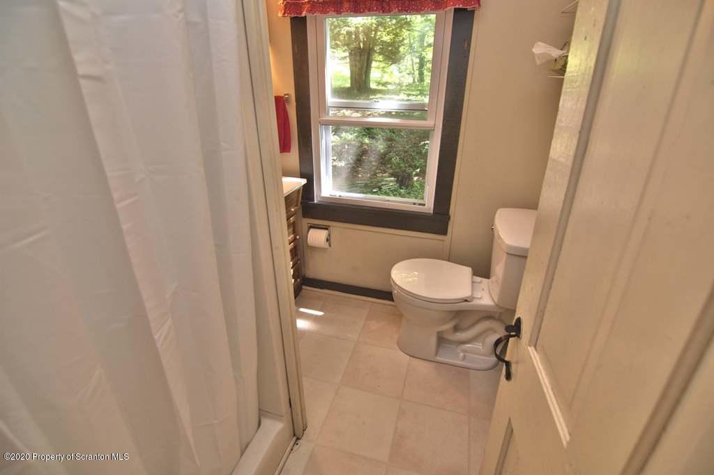 292 Loomis Lk Road Hop Bottom, PA 18824 - Photo 32 of 76 a bathroom with a sink and a toilet