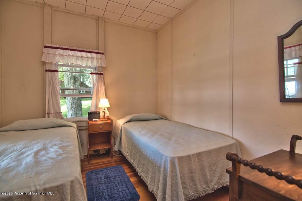 292 Loomis Lk Road Hop Bottom, PA 18824 - Photo 35 of 76 a bedroom with a bed and a window