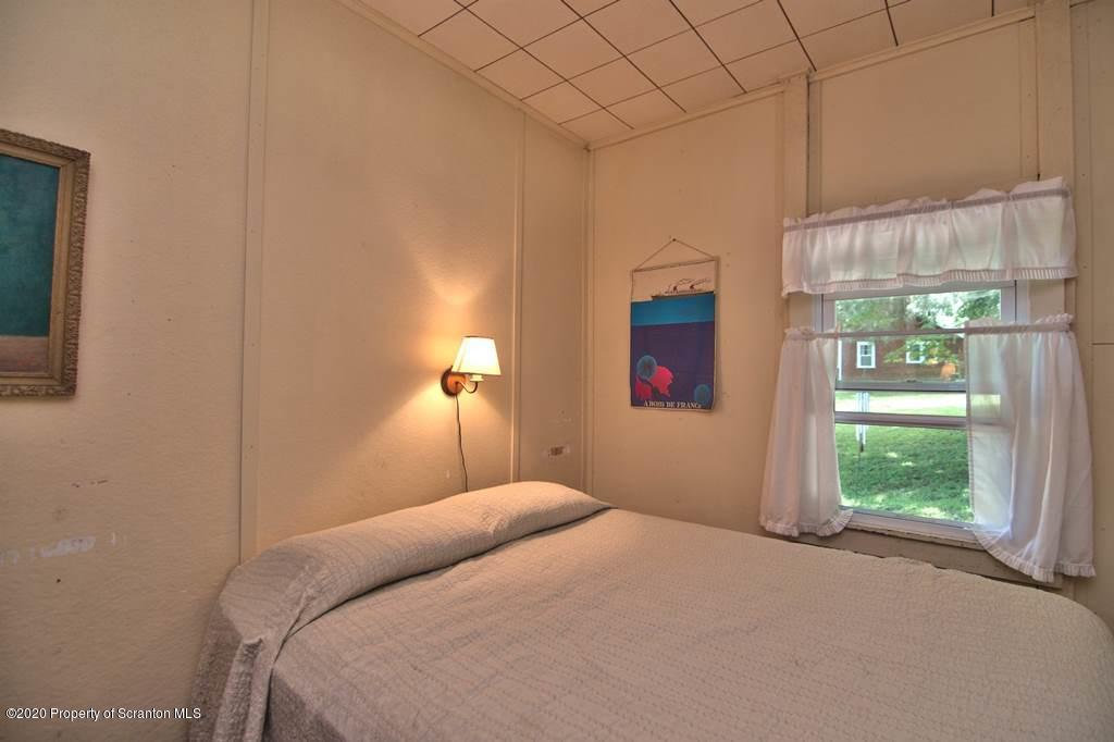 292 Loomis Lk Road Hop Bottom, PA 18824 - Photo 38 of 76 a bedroom with a bed and a window