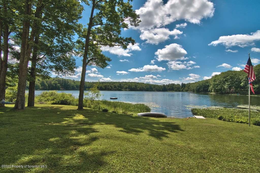 292 Loomis Lk Road Hop Bottom, PA 18824 - Photo 45 of 76 a view of a lake with houses in the background