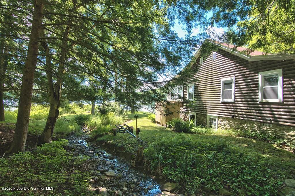 292 Loomis Lk Road Hop Bottom, PA 18824 - Photo 64 of 76 a backyard of a house with lots of green space