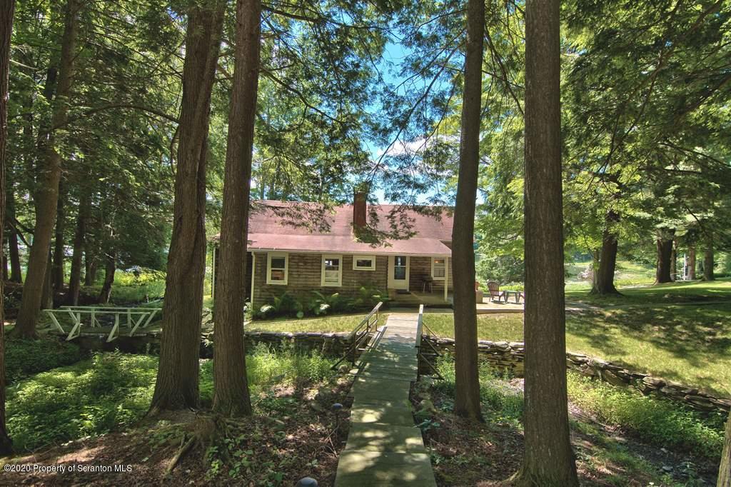 292 Loomis Lk Road Hop Bottom, PA 18824 - Photo 66 of 76 a backyard of a house with lots of green space and fountain
