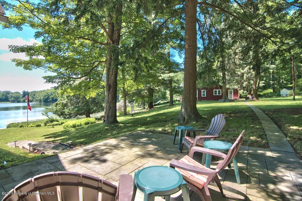 292 Loomis Lk Road Hop Bottom, PA 18824 - Photo 68 of 76 a backyard of a house with yard table and chairs