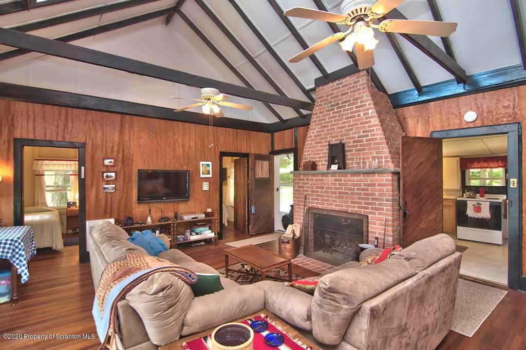 292 Loomis Lk Road Hop Bottom, PA 18824 - Photo 10 of 76 a living room with fireplace furniture and a flat screen tv
