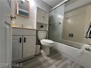 a bathroom with a toilet sink and shower