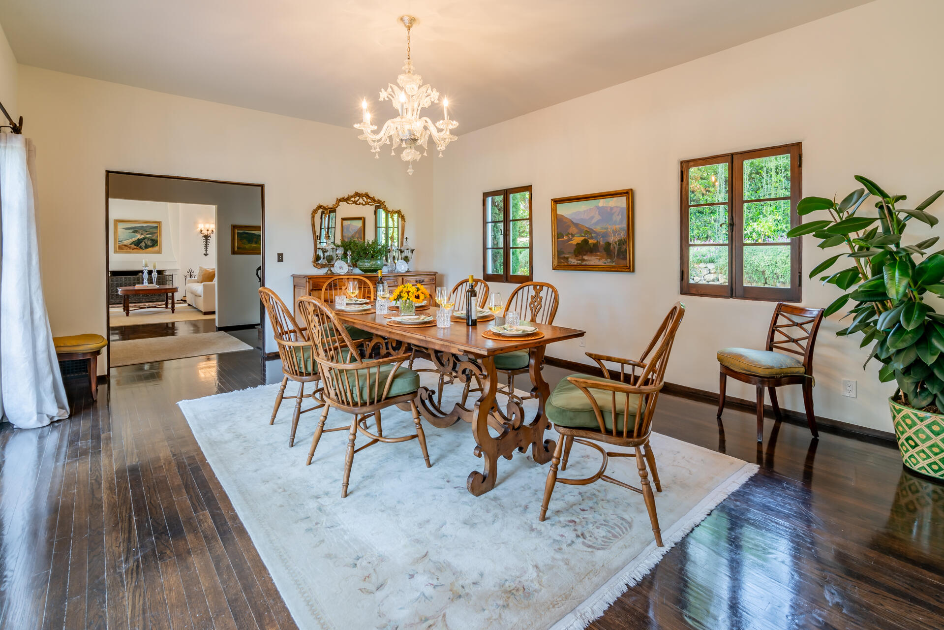 1098 Golf Road Montecito, CA 93108 - Photo 24 of 72 a dining room with wooden floor a chandelier a wooden table and chairs